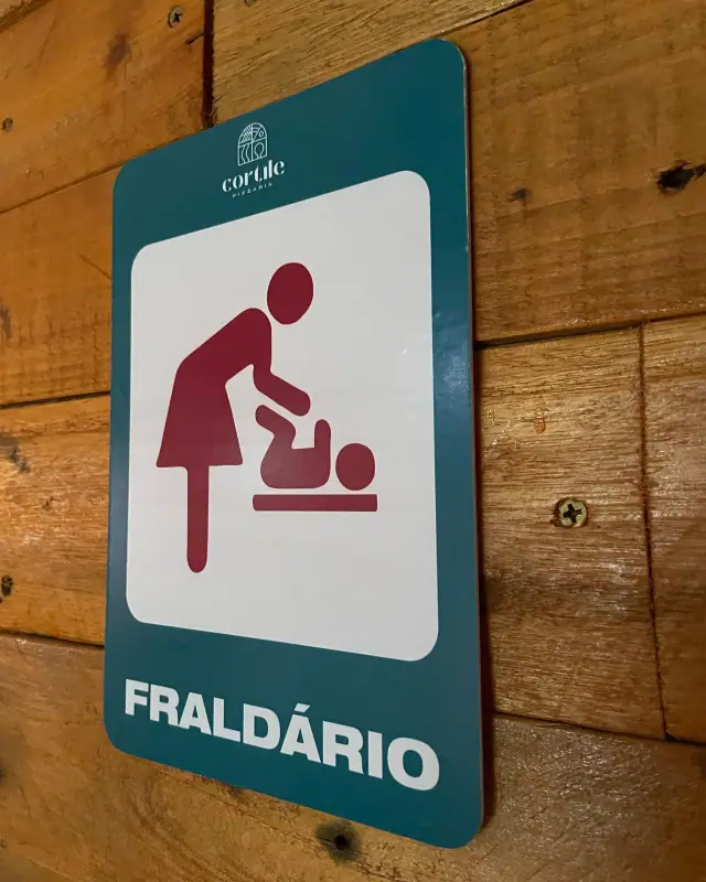 Placa verde de fraldário aplicada em madeira